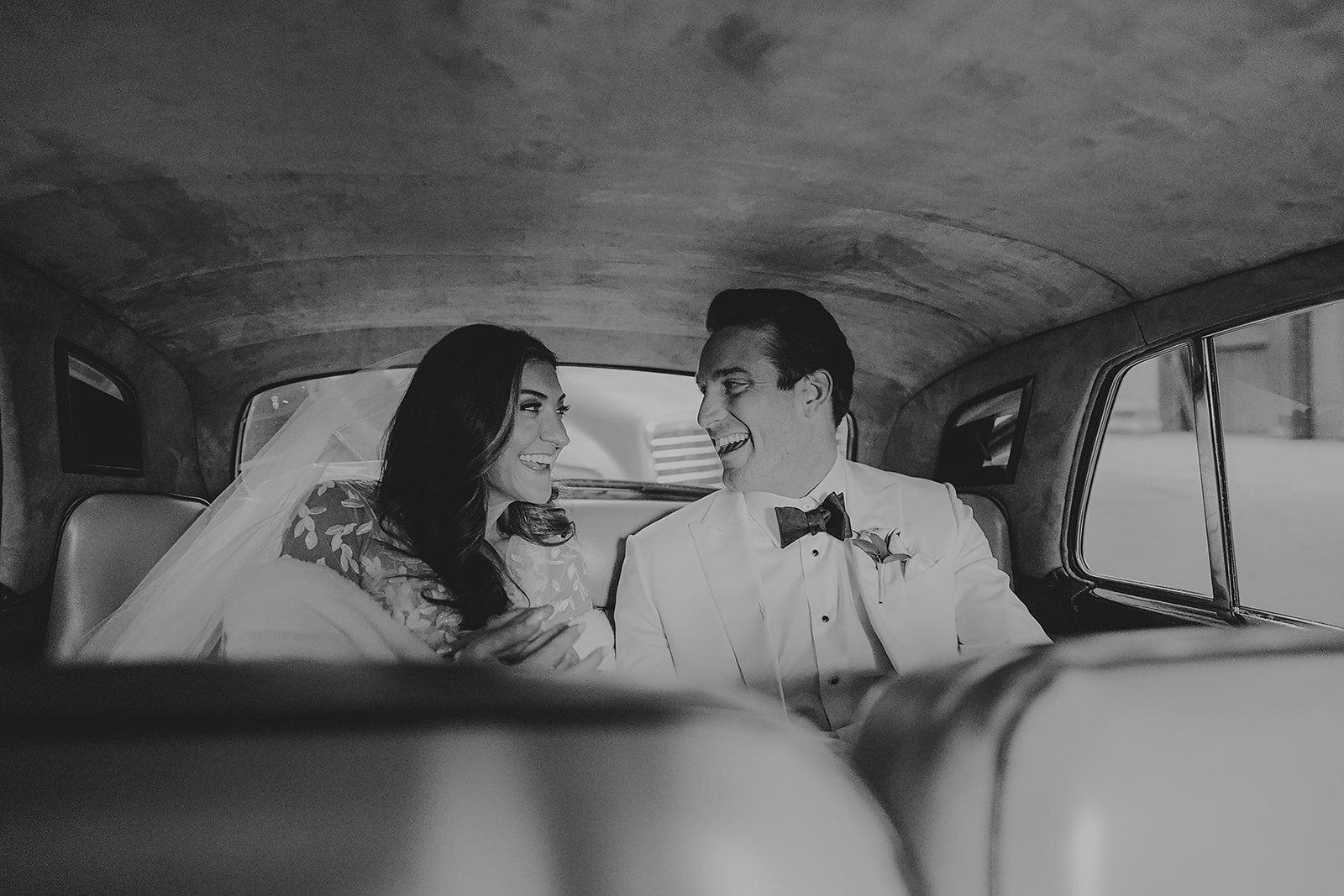 Angela and Jimmy laughing together in a car after their Union League wedding